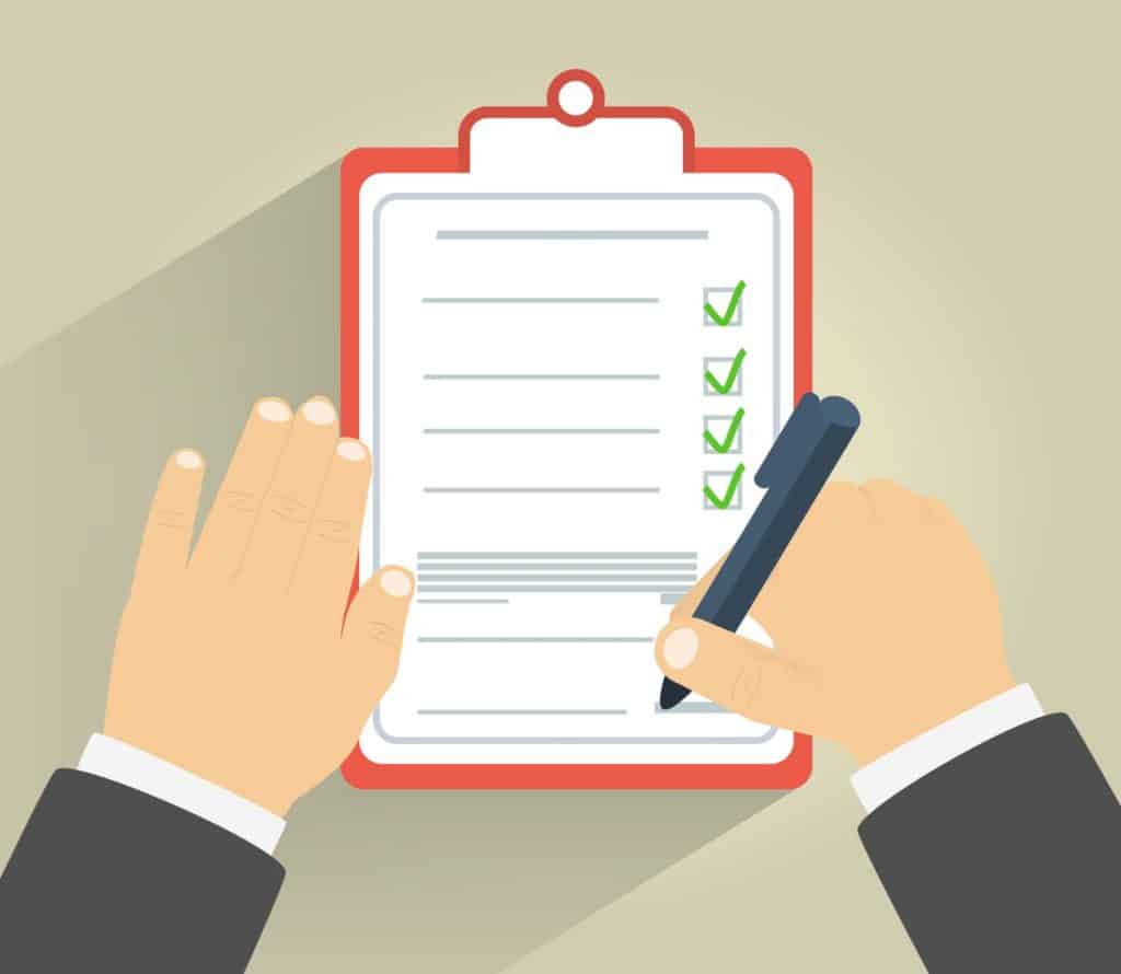 Businessman holding a clipboard and writing signature