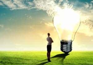Image-of-businesswoman-looking-at-light-bulb-Green-energy-concept