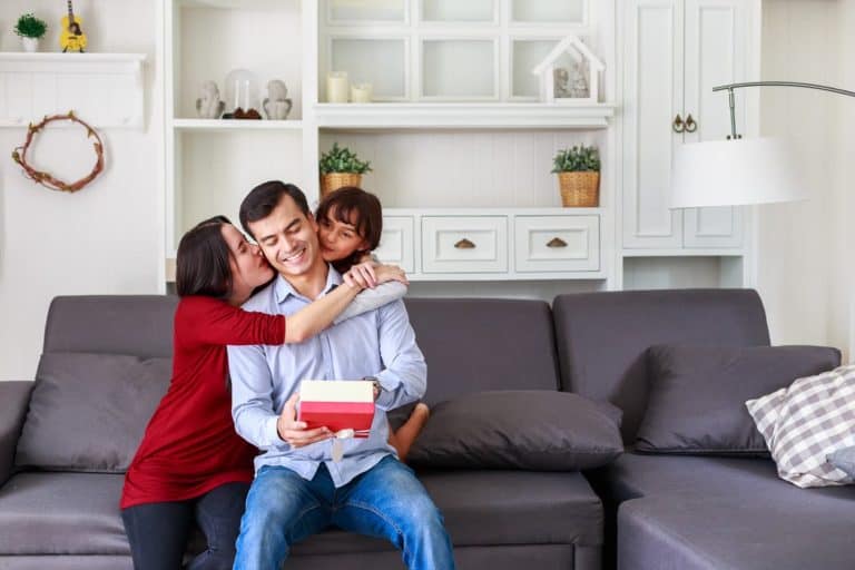Daughter and mother surprising father with gift